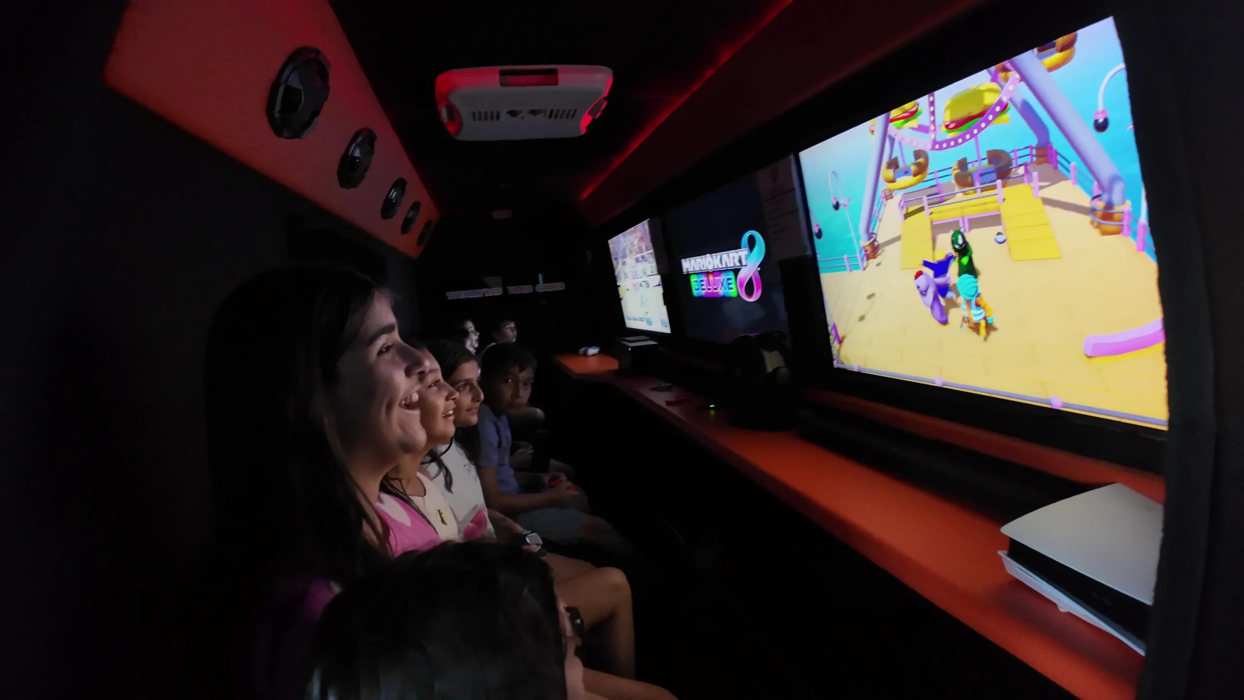 Kids playing video games inside the Totally Rad game truck